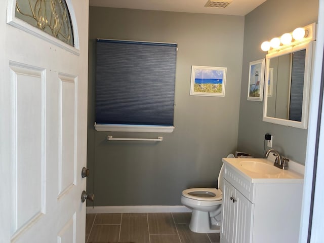 bathroom featuring vanity and toilet