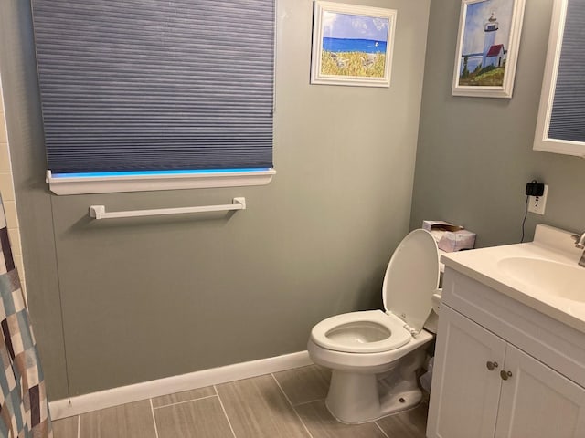 bathroom featuring vanity, toilet, and walk in shower