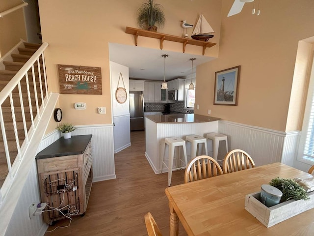 dining space featuring hardwood / wood-style floors and ceiling fan