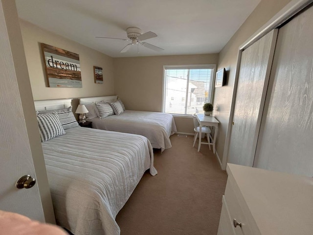 carpeted bedroom featuring ceiling fan and a closet