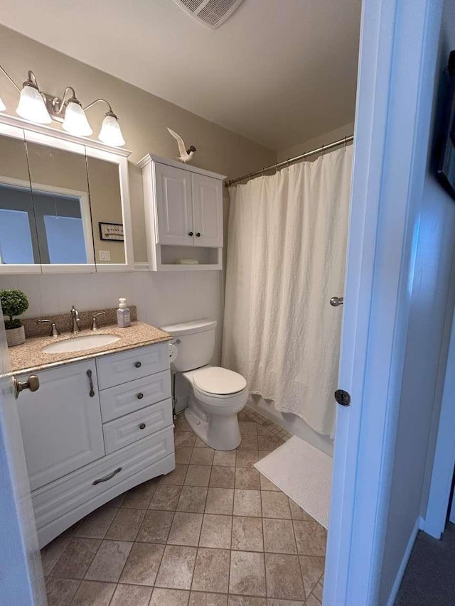 bathroom with vanity, tile patterned floors, and toilet