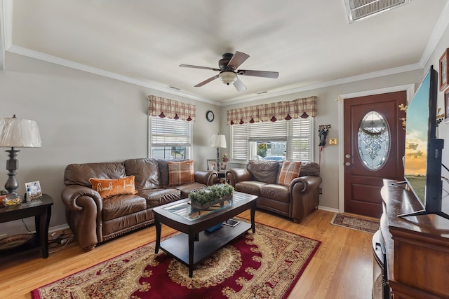 living room featuring ceiling fan, light wood-style flooring, and crown molding