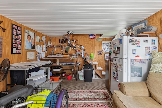misc room with wooden walls, a workshop area, and carpet flooring