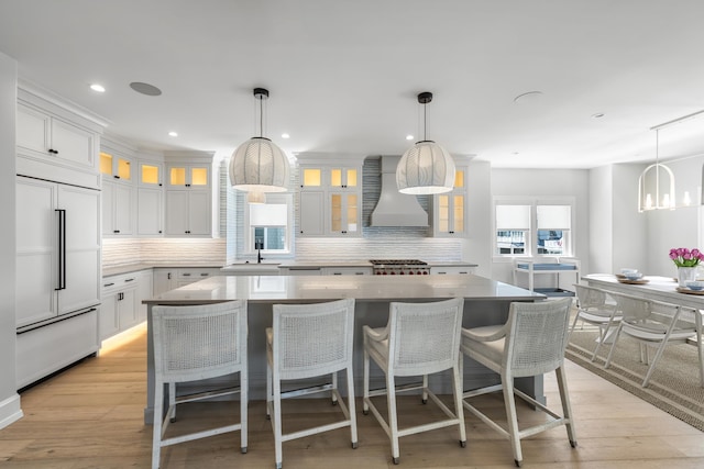 207 120th St, Stone Harbor, NJ 08247 - kitchen featuring paneled fridge, custom range hood, decorative backsplash, a kitchen island, and recessed lighting