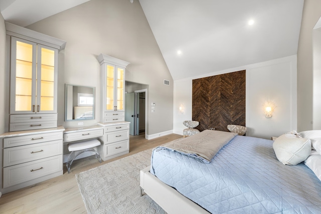 207 120th St, Stone Harbor, NJ 08247 - bedroom with light wood-type flooring, high vaulted ceiling, and built in desk