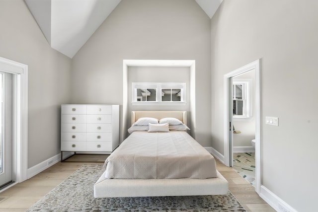 207 120th St, Stone Harbor, NJ 08247 - bedroom featuring vaulted ceiling, light wood-style flooring, and ensuite bathroom
