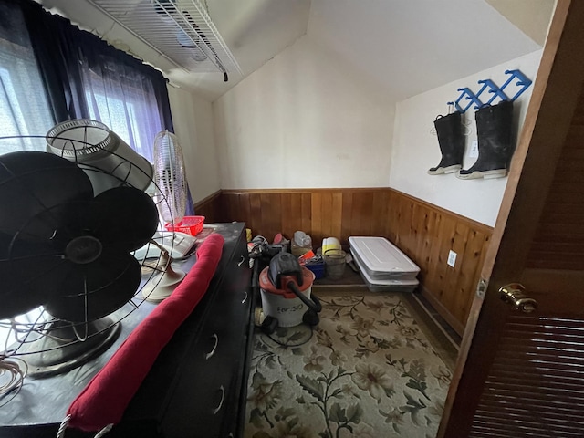 interior space with lofted ceiling and wooden walls