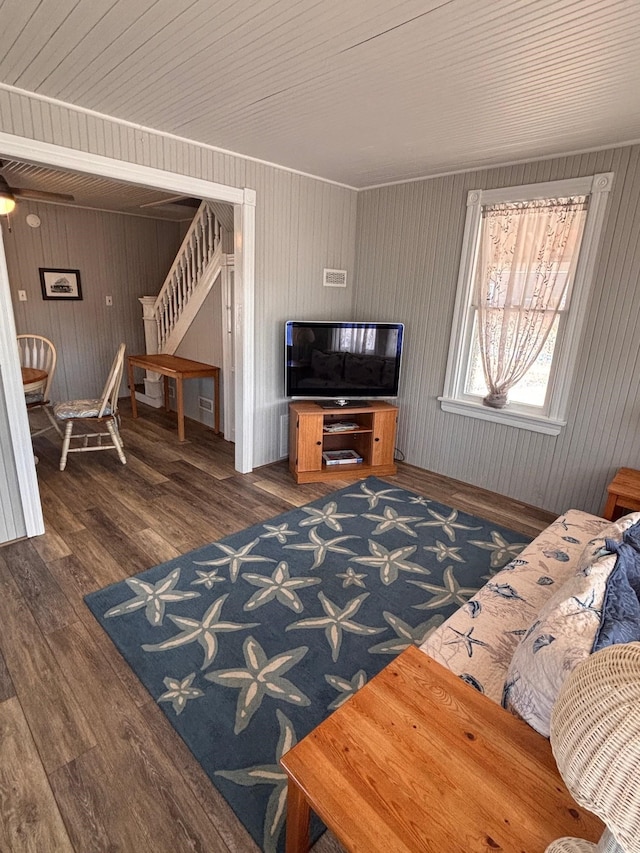 living area with stairway and wood finished floors