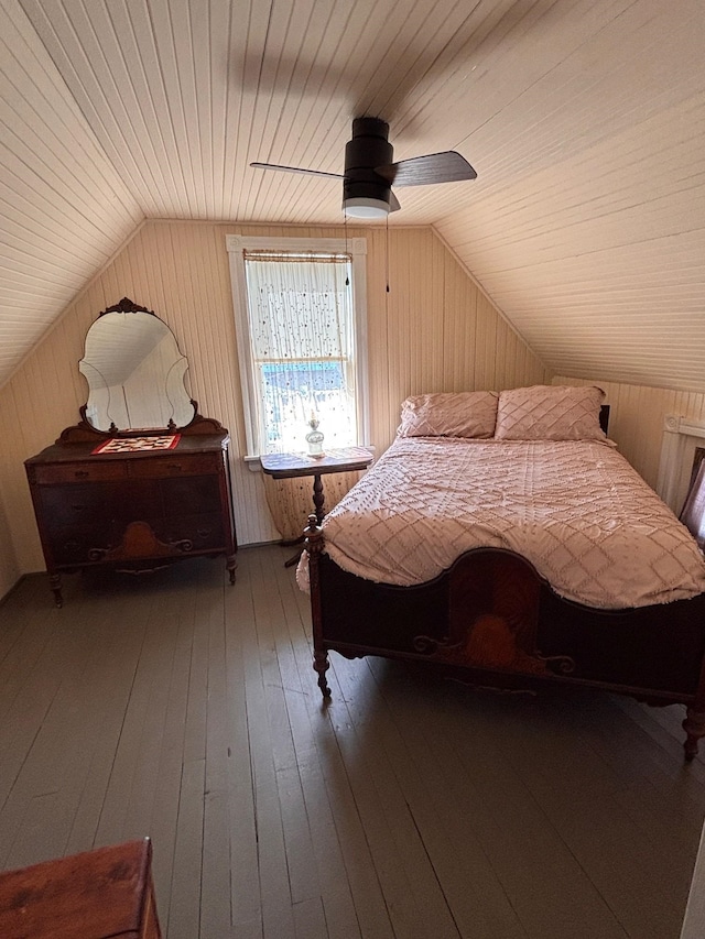 bedroom featuring vaulted ceiling, wooden walls, wood ceiling, and wood-type flooring