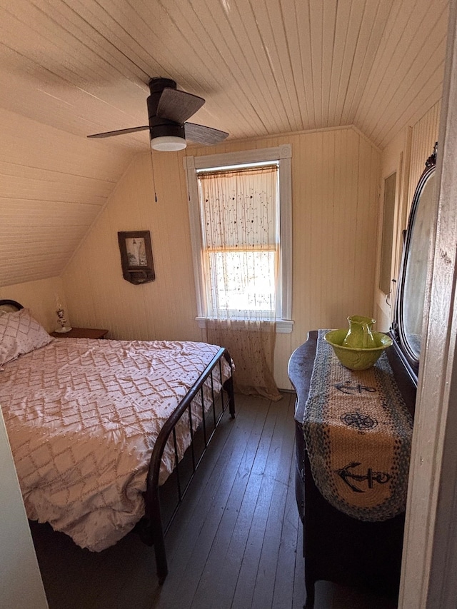 bedroom featuring a ceiling fan, dark wood-type flooring, vaulted ceiling, wood walls, and wooden ceiling