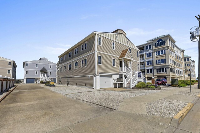 127 W Spruce Ave Unit B, North Wildwood, NJ 08260 - view of property with stairway, an attached garage, and driveway