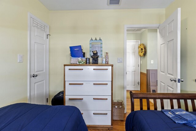 127 W Spruce Ave Unit B, North Wildwood, NJ 08260 - bedroom featuring wood finished floors, ornamental molding, and a wainscoted wall
