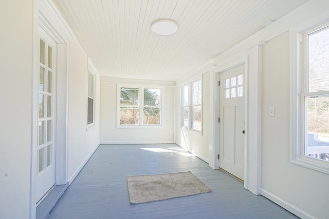 unfurnished sunroom featuring wood ceiling