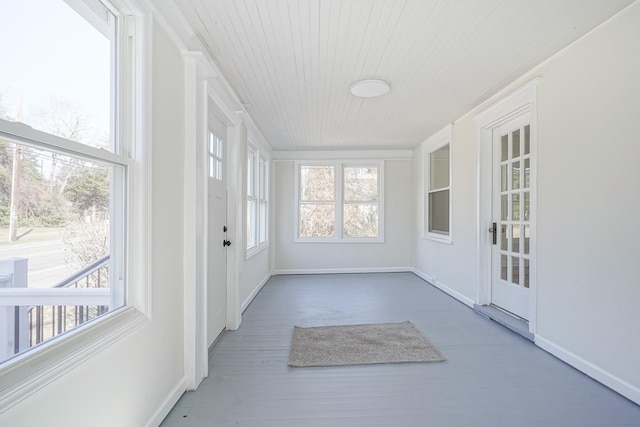 unfurnished sunroom with wooden ceiling