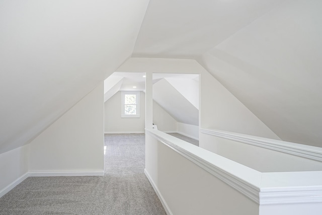 additional living space with lofted ceiling, baseboards, and carpet flooring