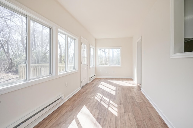 unfurnished sunroom featuring a baseboard heating unit