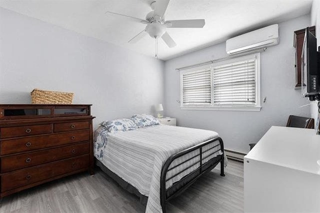 301 E Lavender Rd Unit 2, Wildwood, NJ 08260 - bedroom with light wood finished floors, a wall mounted AC, baseboard heating, and a ceiling fan