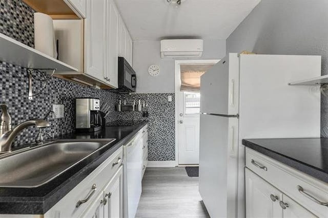 301 E Lavender Rd Unit 2, Wildwood, NJ 08260 - kitchen featuring an AC wall unit, dark countertops, light wood-style floors, and black microwave