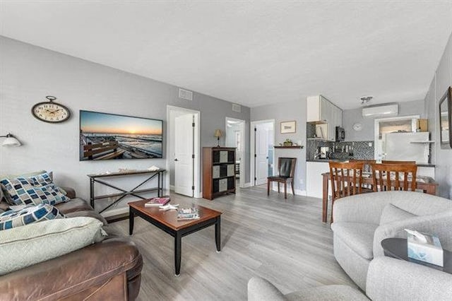 301 E Lavender Rd Unit 2, Wildwood, NJ 08260 - living area featuring light wood-type flooring and a wall mounted air conditioner