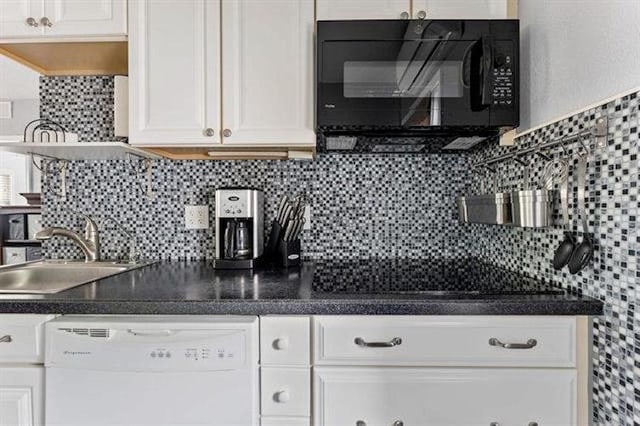 301 E Lavender Rd Unit 2, Wildwood, NJ 08260 - kitchen with black appliances, white cabinets, backsplash, and dark countertops