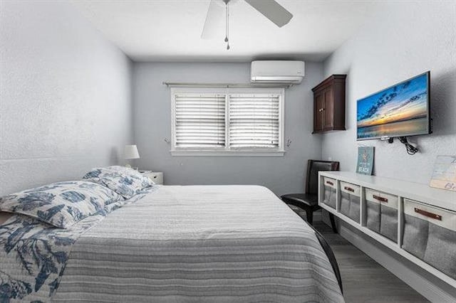 301 E Lavender Rd Unit 2, Wildwood, NJ 08260 - bedroom featuring a wall unit AC, dark wood-style flooring, and a ceiling fan