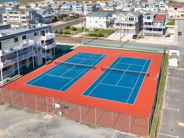 view of tennis court with basketball hoop