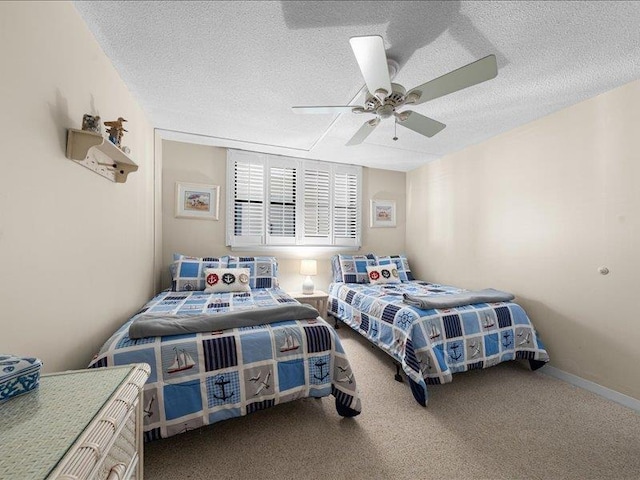 bedroom featuring a textured ceiling, ceiling fan, and carpet