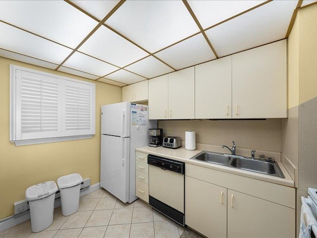 kitchen with sink, white appliances, a paneled ceiling, and white cabinets