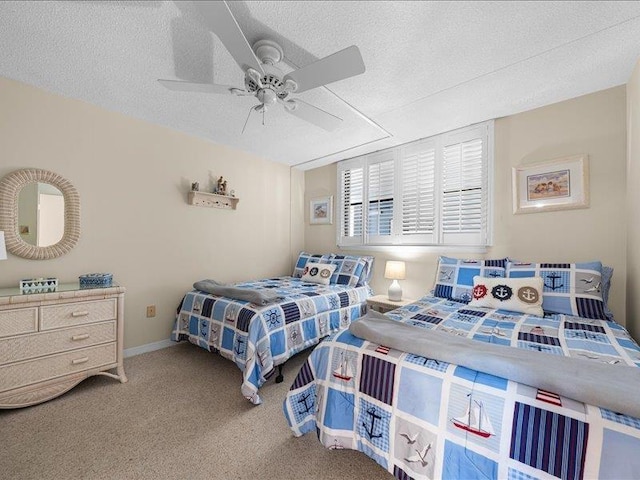 carpeted bedroom with ceiling fan and a textured ceiling