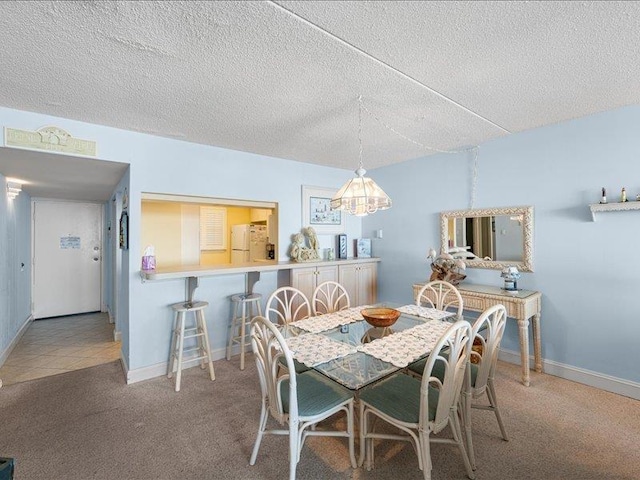 carpeted dining area with a textured ceiling