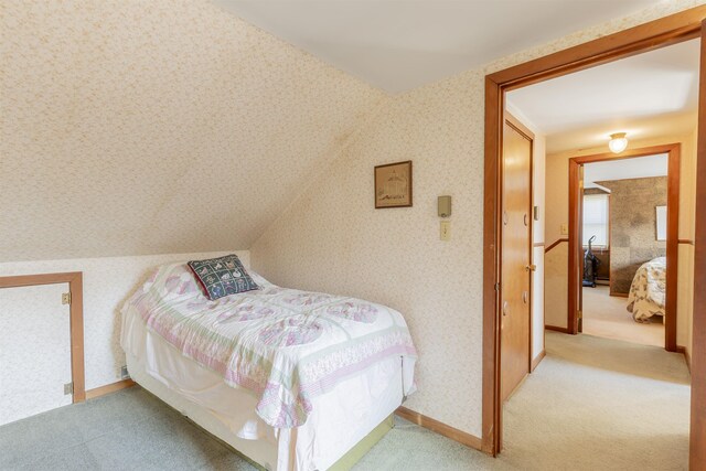 carpeted bedroom with wallpapered walls and baseboards