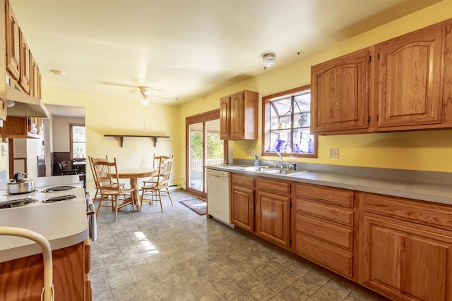 kitchen featuring light countertops, white dishwasher, tile patterned floors, and a sink