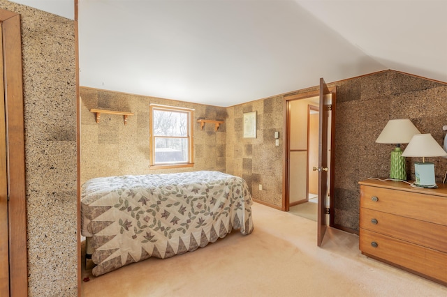 bedroom featuring vaulted ceiling and light colored carpet