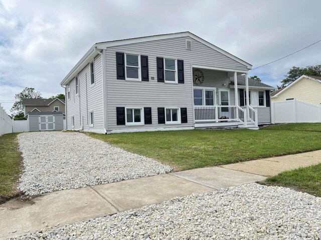 712 Indian Ave, North Cape May, NJ 08204 - back of house with covered porch, a storage shed, and driveway