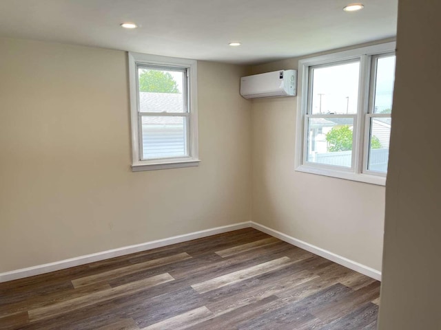 712 Indian Ave, North Cape May, NJ 08204 - unfurnished room featuring a wall unit AC, dark wood-type flooring, and recessed lighting