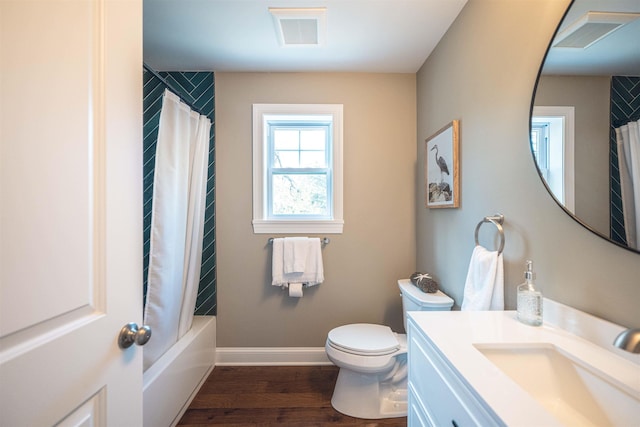 full bathroom with vanity, hardwood / wood-style flooring, toilet, and shower / bath combo with shower curtain