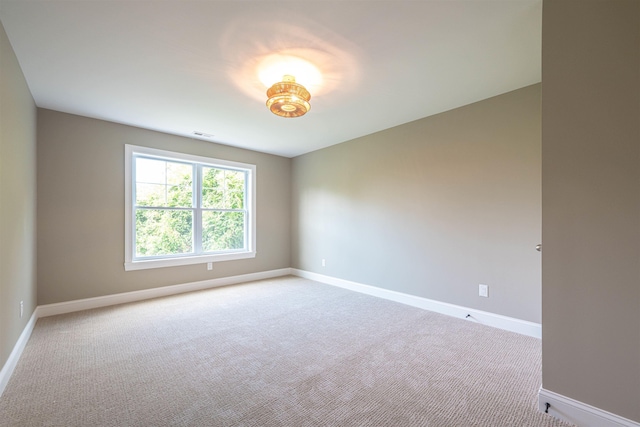 unfurnished room with light colored carpet