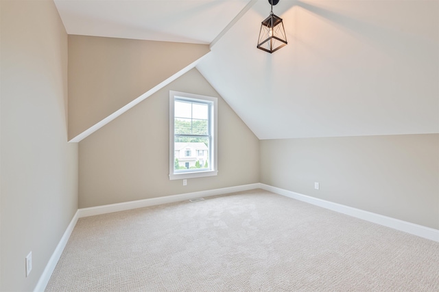 additional living space featuring carpet and vaulted ceiling