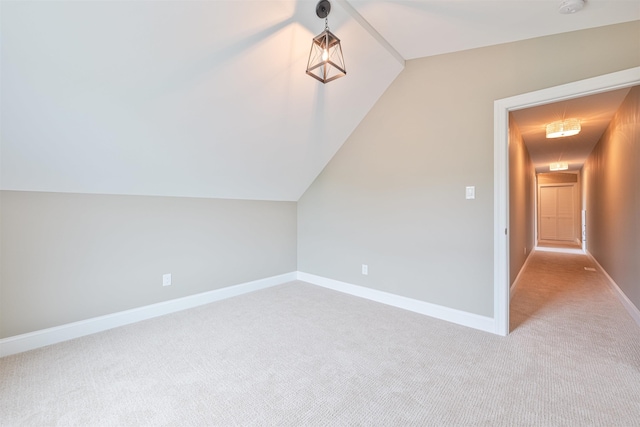 bonus room featuring light colored carpet and vaulted ceiling