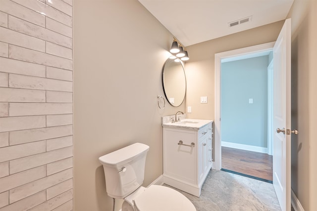 bathroom featuring vanity and toilet