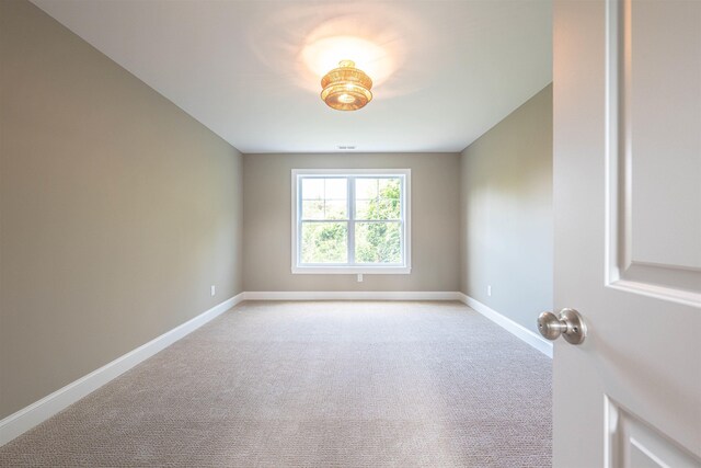 spare room with light colored carpet