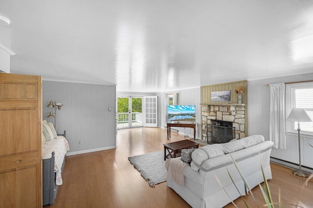 1101 New York Ave, Cape May, NJ 08204 - living area with healthy amount of natural light, a stone fireplace, baseboards, wood finished floors, and ornamental molding