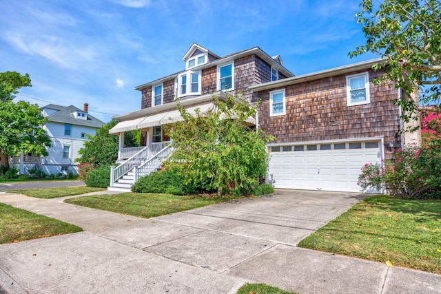 view of front of property featuring a garage and a front yard