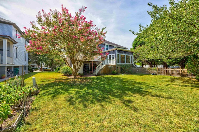 view of yard with a deck and a sunroom