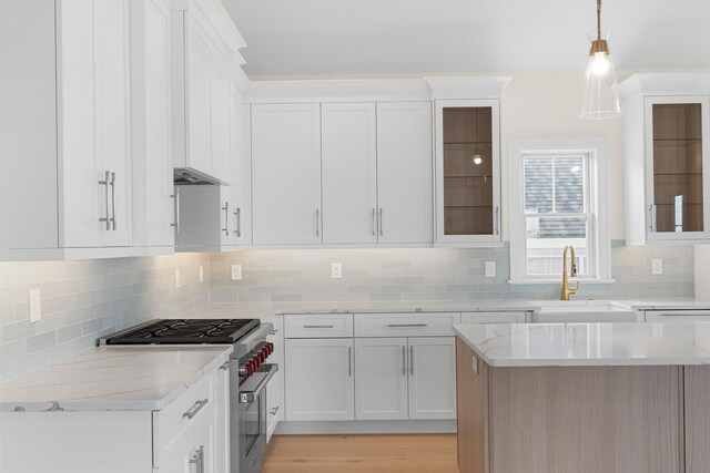 188 34th St, Avalon, NJ 08202 - kitchen featuring high end stove, white cabinets, light stone counters, and tasteful backsplash