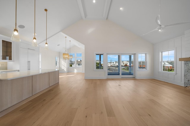 188 34th St, Avalon, NJ 08202 - unfurnished living room featuring high vaulted ceiling, light wood-style flooring, a ceiling fan, and a chandelier