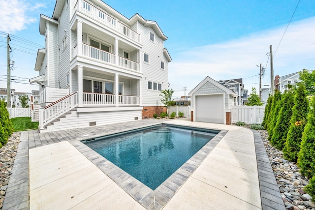 188 34th St, Avalon, NJ 08202 - back of house with a balcony, a garage, a patio area, and an outbuilding