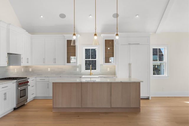 188 34th St, Avalon, NJ 08202 - kitchen with high end stainless steel range oven, a center island, tasteful backsplash, white cabinets, and lofted ceiling