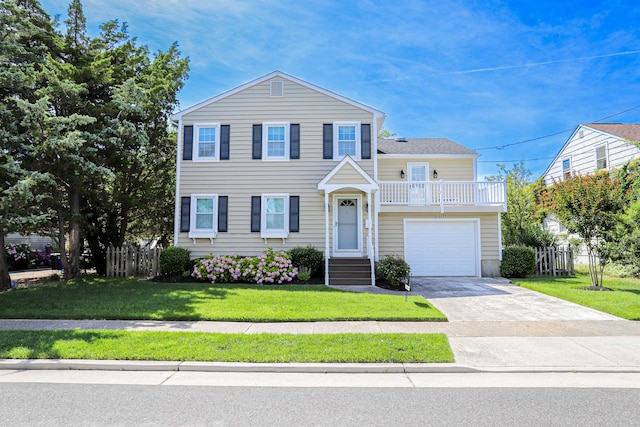 view of front of house with a garage and a front lawn