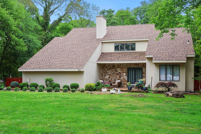 6 Rabbit Run, North Cape May, NJ 08204 - view of front facade featuring roof with shingles, fence, stone siding, a front lawn, and a chimney